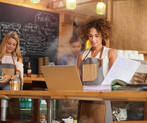 Business owner using a laptop computer to manage finances