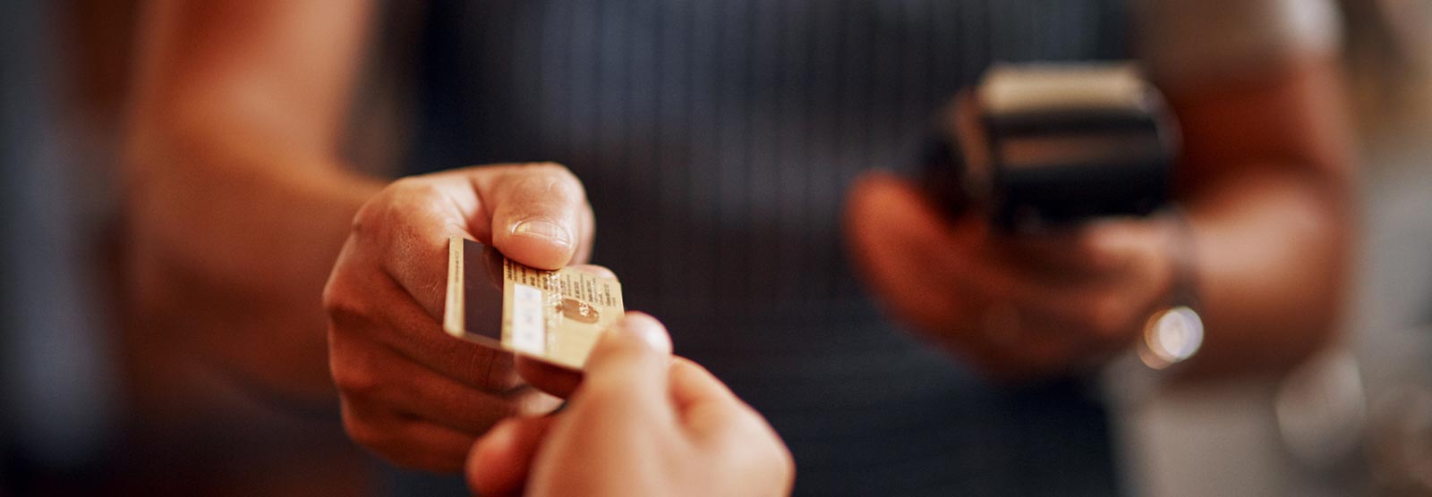 Personal using a debit card at a store front