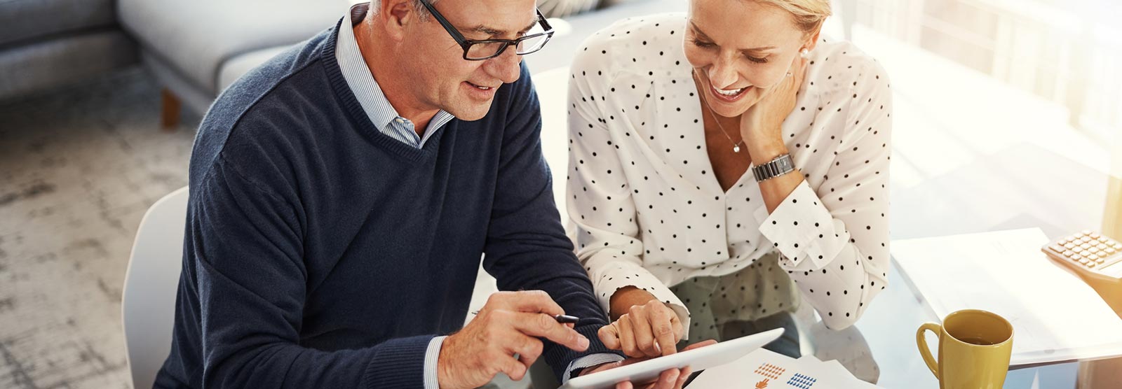 Couple looking at investments and finances on a smart tablet