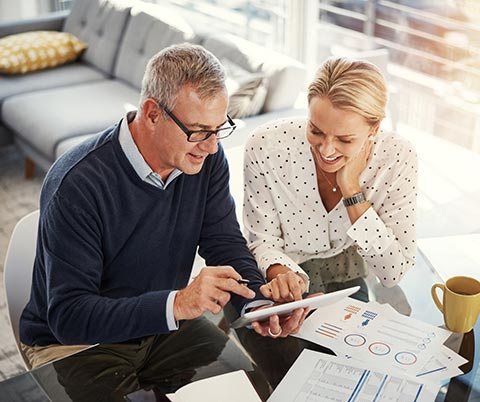 Couple going over finances on a smart tablet